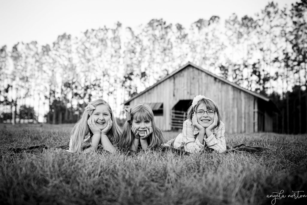 kids-smiling-in-front-of-barn-angela-norton-photography